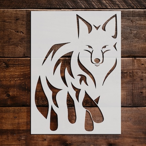 stencil of fox against dark brown wood